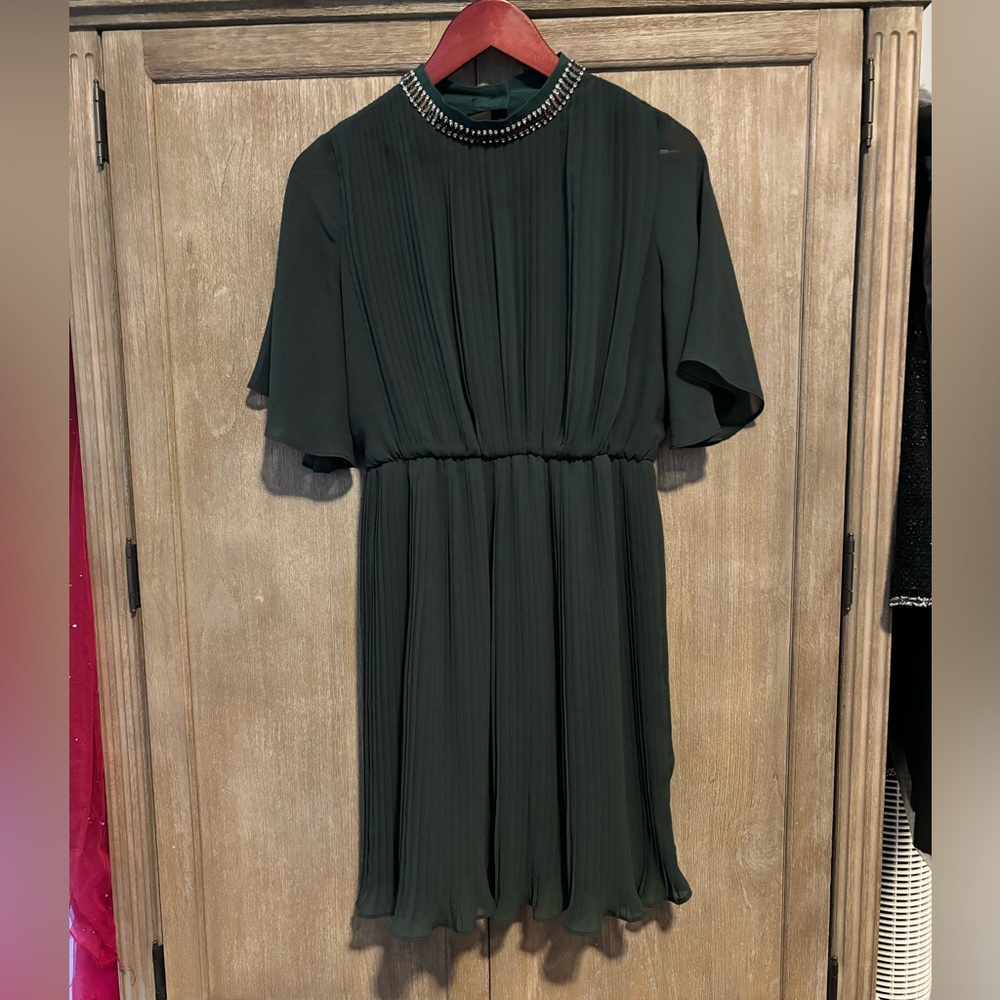 A dark green dress of an unknown brand. size M